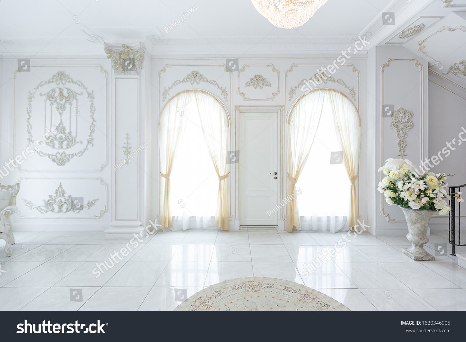 luxury royal posh interior in baroque style. very bright, light and white hall with expensive oldstyle furniture. large windows and stucco ornament decorations on the walls #1820346905
