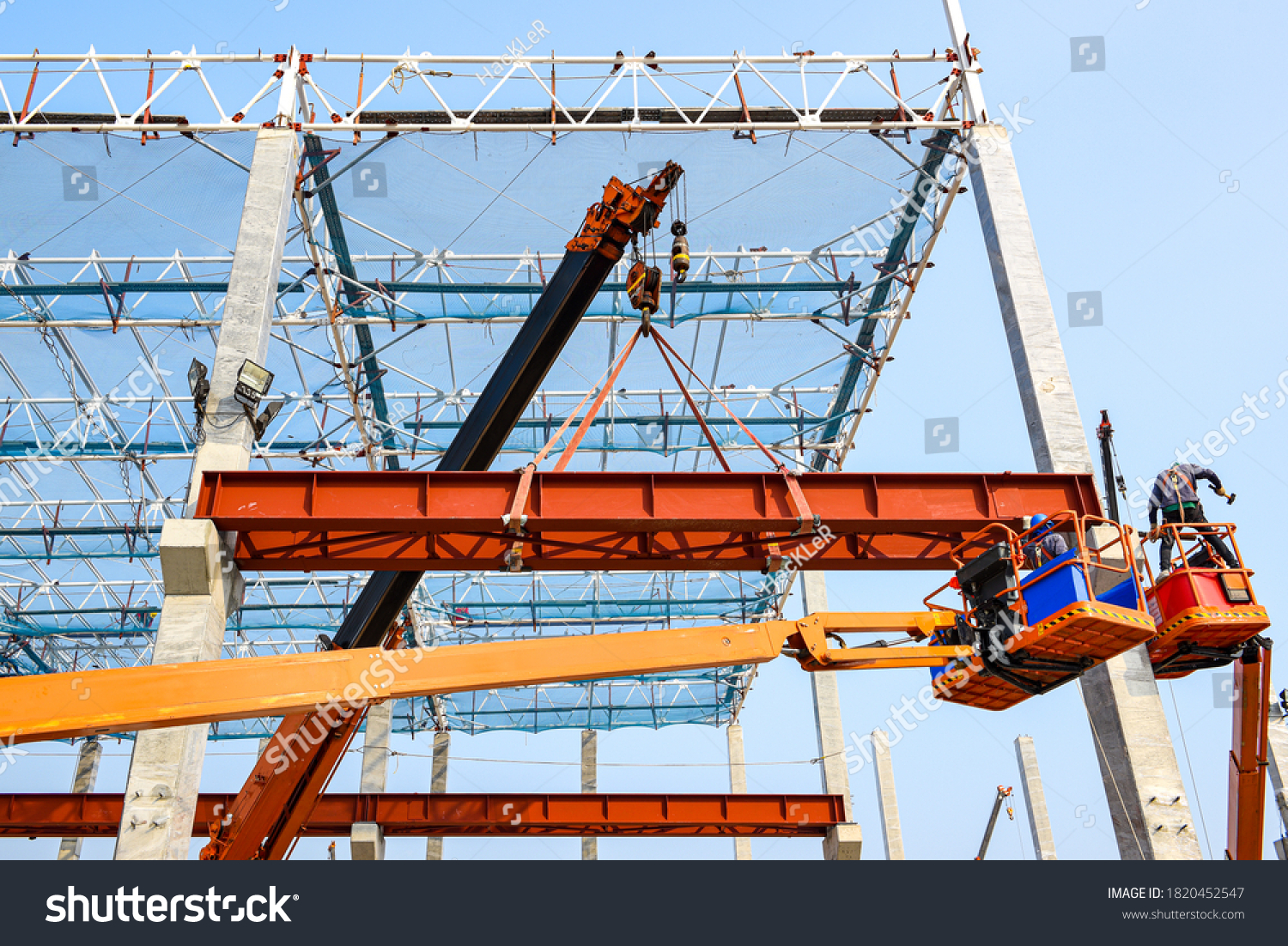 Construction workers installation steel structure girder runway beam lifting by mobile crane and placing on corbel of column concrete at the construction site project #1820452547