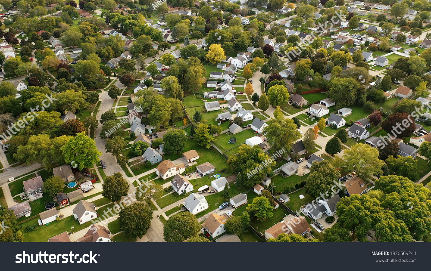 Aerial drone view of American suburban neighborhood at daytime. Establishing shot of America's  suburb. Residential single family houses pattern #1820569244