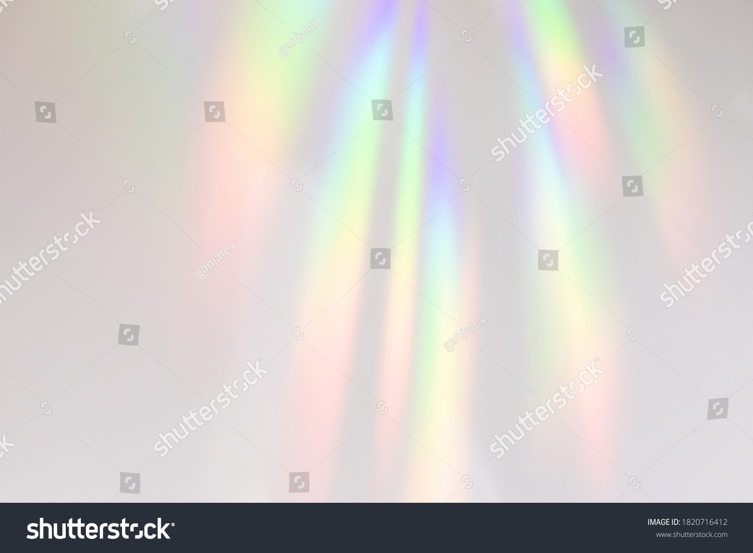 Blurred rainbow light refraction texture overlay effect for photo and mockups. Organic drop diagonal holographic flare on a white wall. Shadows for natural light effects #1820716412