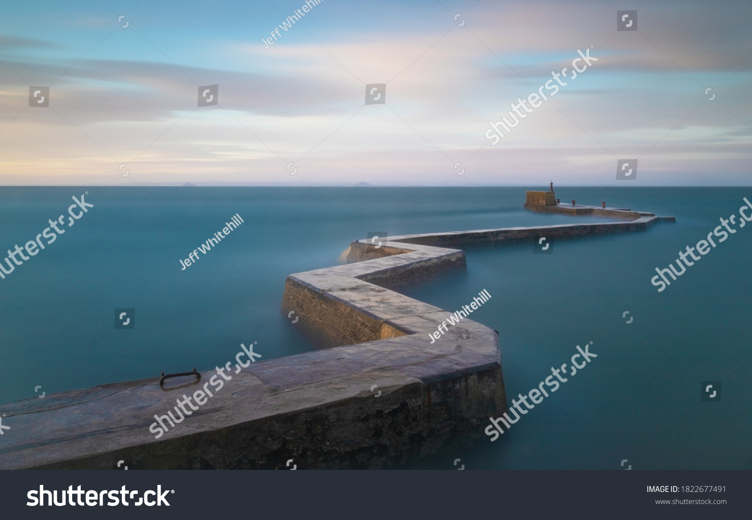 A long exposure shot of the zigzag breakwater at St Monans during some stormy weather - the long exposure smooths out the water giving the appearance of calm #1822677491