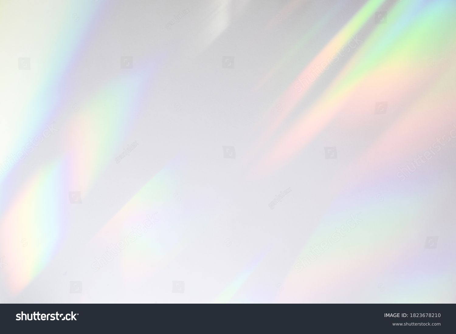 Blurred rainbow light refraction texture overlay effect for photo and mockups. Organic drop diagonal holographic flare on a white wall. Shadows for natural light effects #1823678210