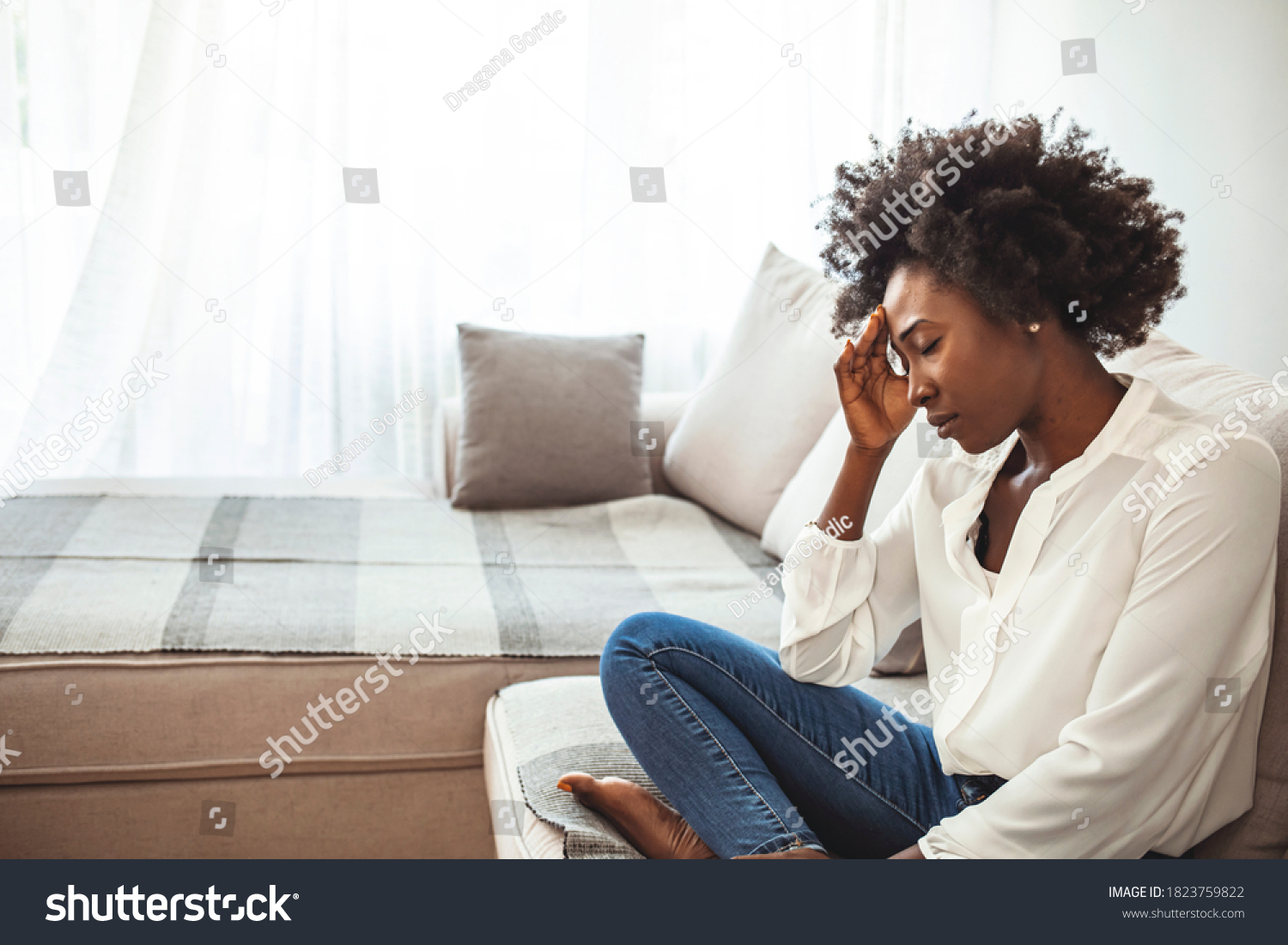 Close up african female sit on couch feels unhappy desperate thinking about personal difficulties mental health problems, 30s sad woman need psychological support goes through divorce break up concept #1823759822