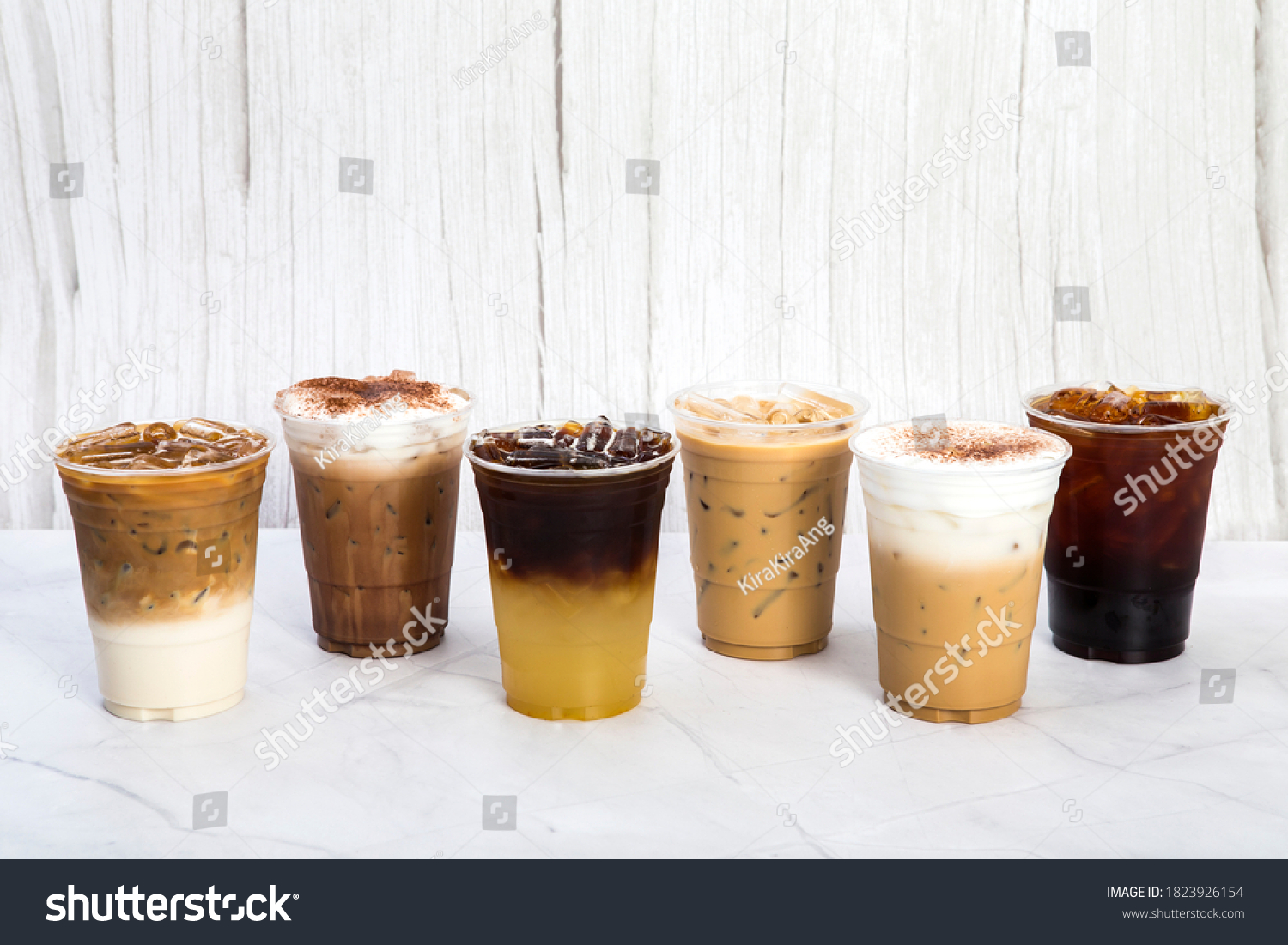 group of iced coffee in plastic glass latte mocha yuzu espresso cappuccino americano are arranging in white and clear wooden background #1823926154