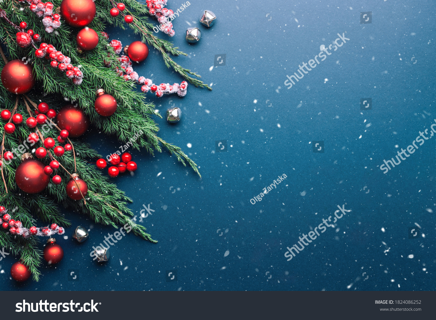 Christmas border with fir branches and red decorations on blue background with snow. #1824086252