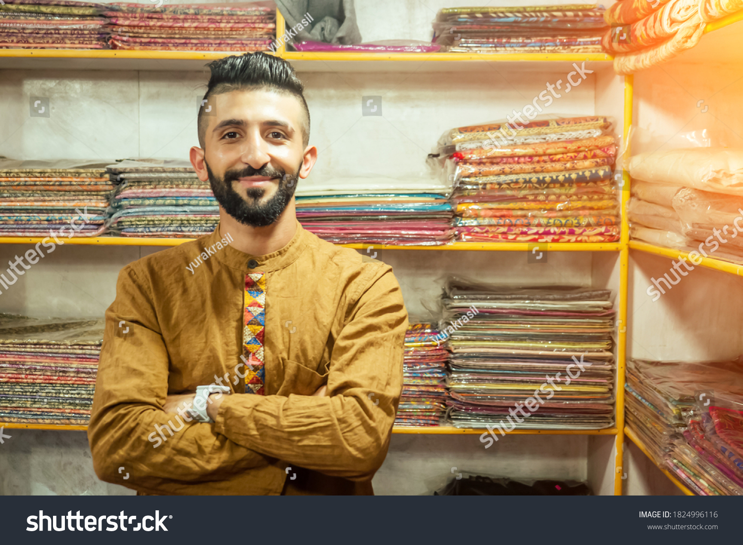 small shop owner indian man selling shawls at his store #1824996116