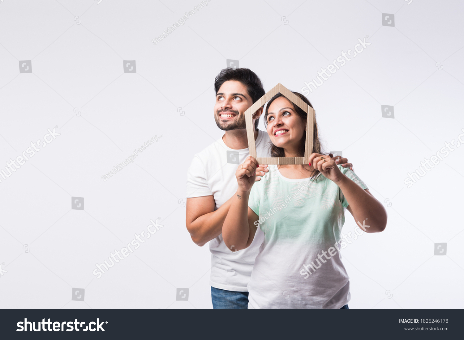 Indian young family couple and real estate concept - buying or rental, standing against white background #1825246178