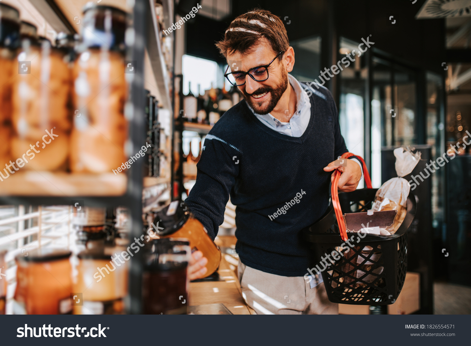 Handsome middle age man buying some healthy food and drink in modern supermarket or grocery store. Lifestyle and consumerism concept. #1826554571