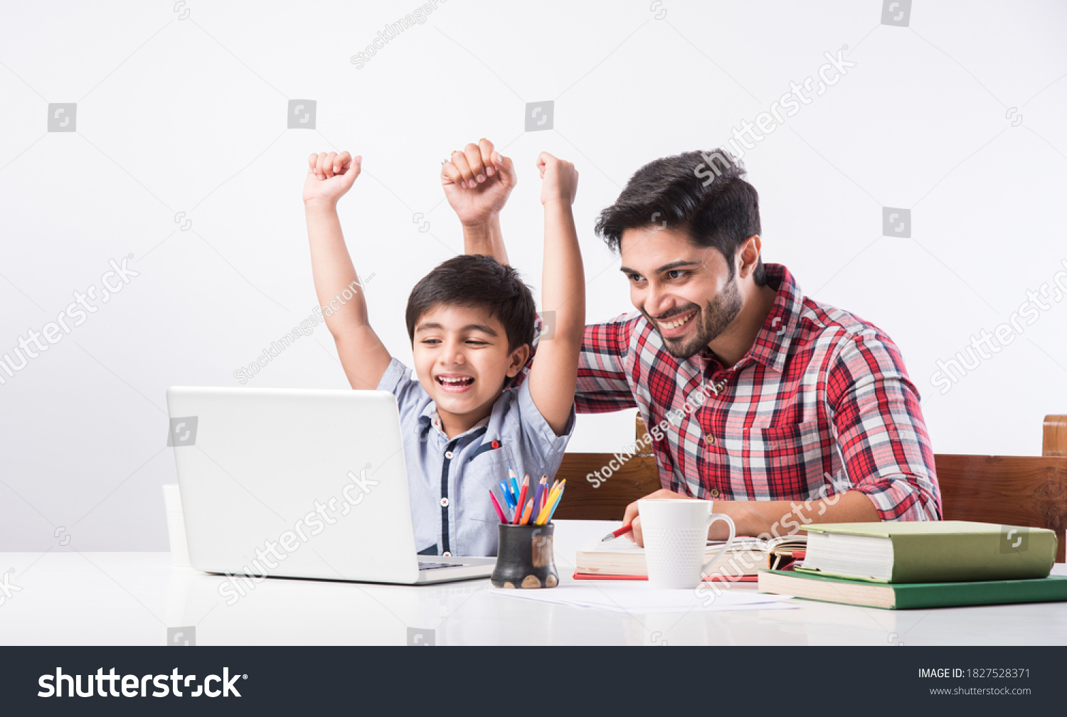 Indian kid studying online, attending school via e-learning with father #1827528371