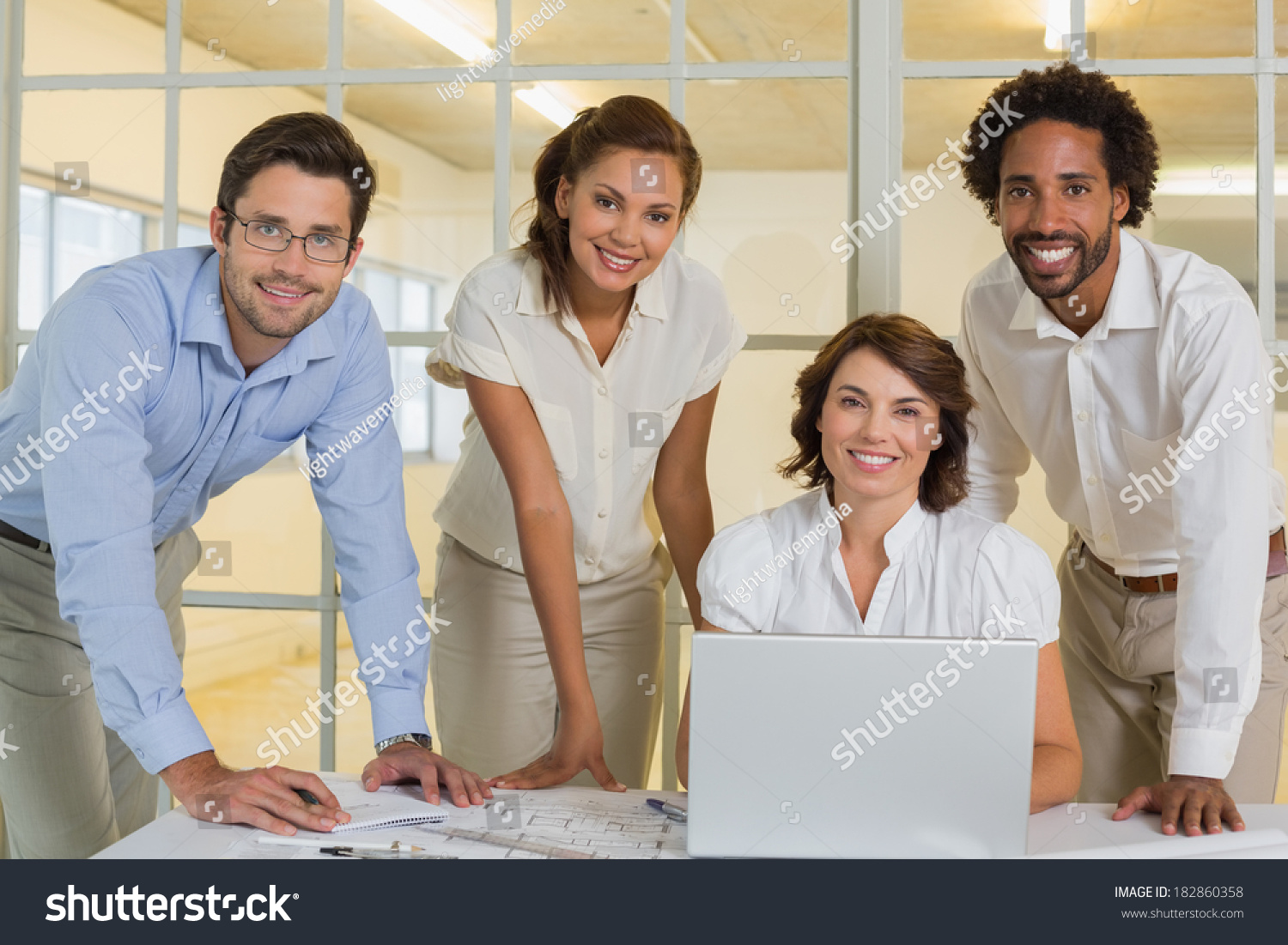 Portrait of happy business people using laptop in meeting at the office #182860358
