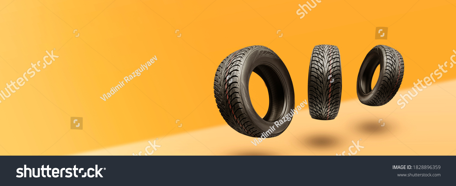 winter tires - panoramic concept with copyspace for the site header on a bright orange background. sale of tires or spare parts for the car. #1828896359