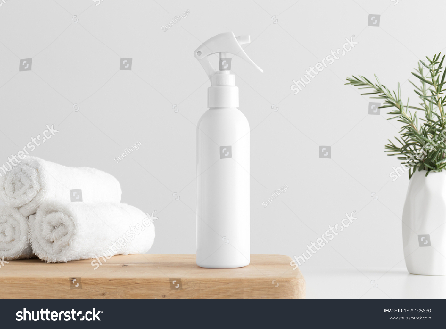 White cosmetic trigger sprayer bottle mockup with towels and a rosemary on a wooden table. #1829105630