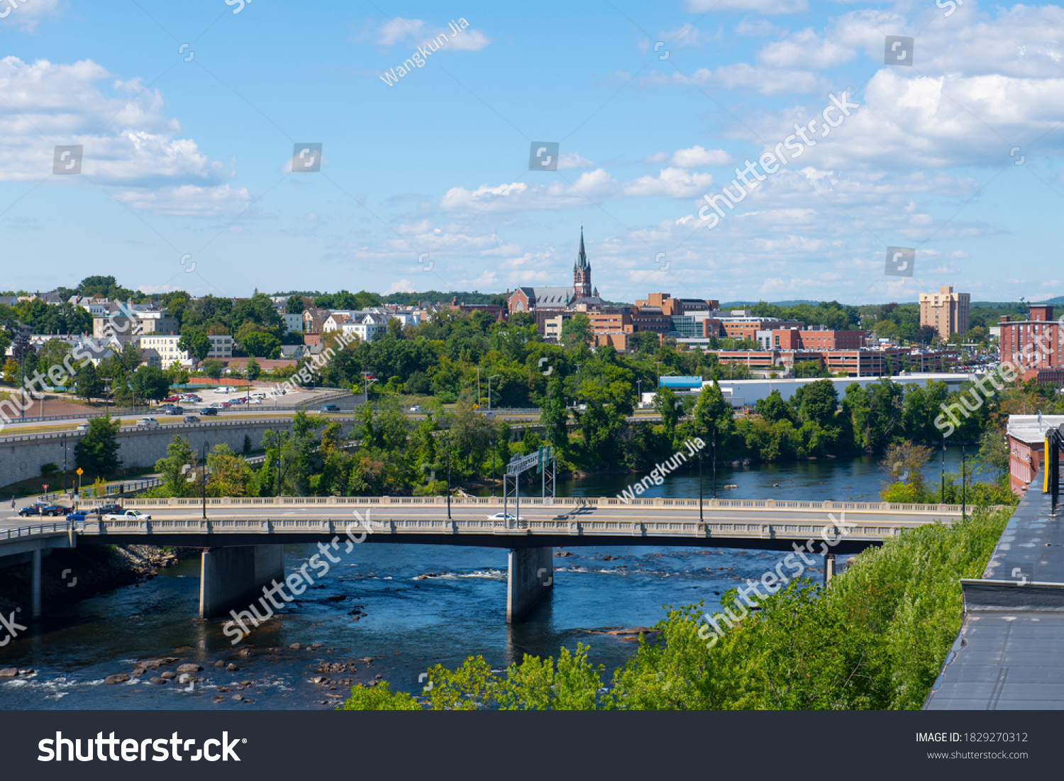 Manchester historic city skyline including Merrimack River, Granite Street Bridge and West Side Sainte Marie Parish church in Manchester, New Hampshire NH, USA.  #1829270312