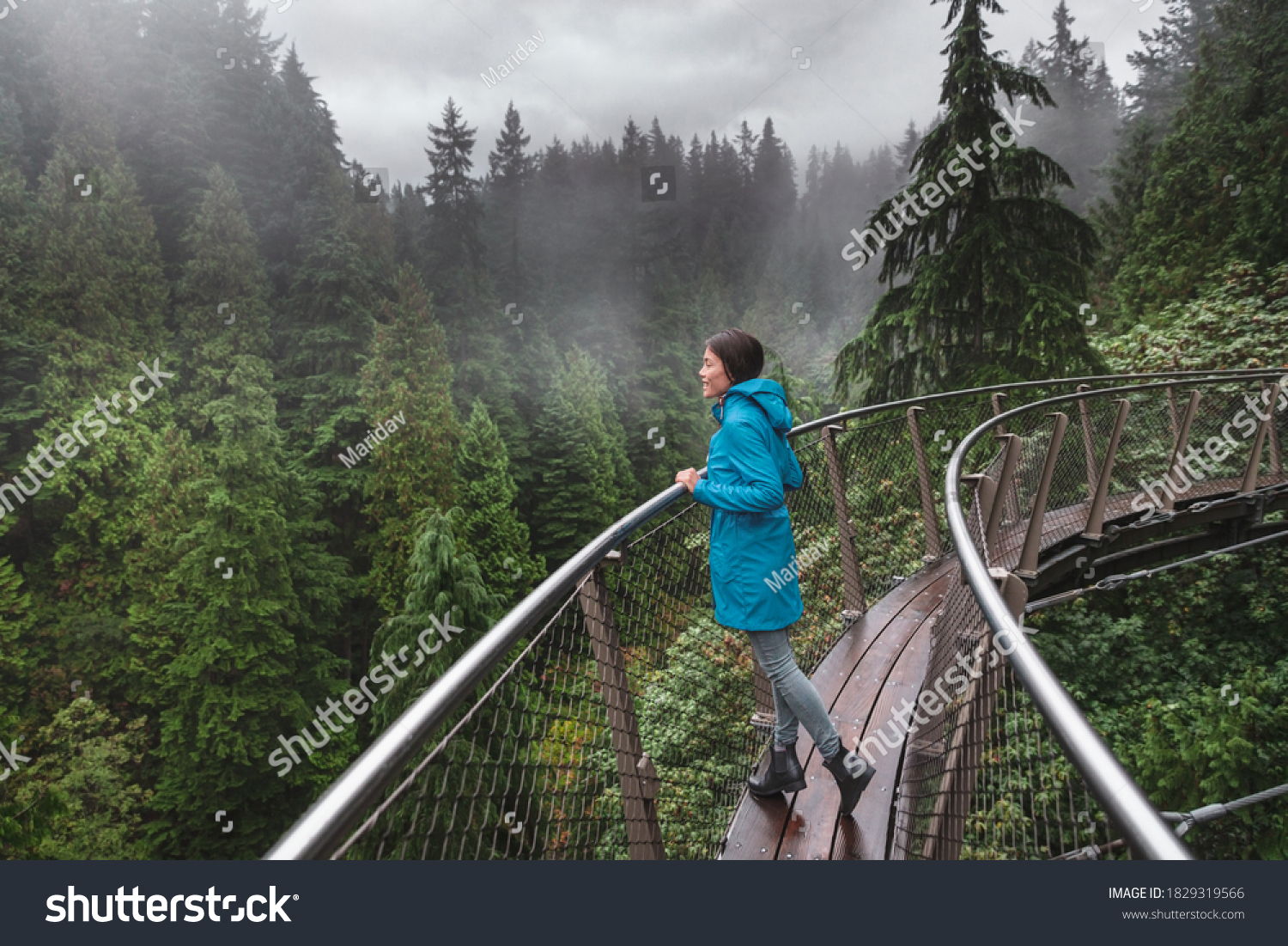 Canada Autumn travel destination in British Columbia. Asian tourist woman walking in famous attraction Capilano Suspension Bridge Park in North Vancouver, canadian vacation for tourism. #1829319566