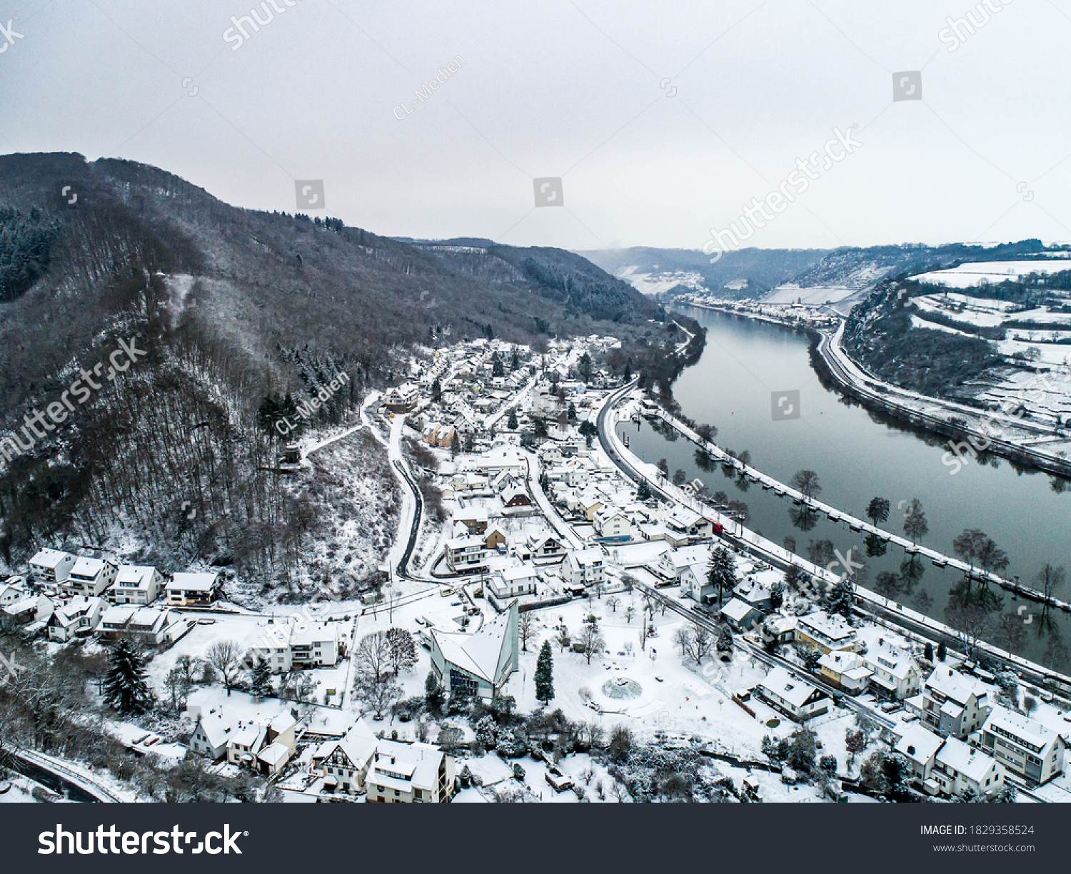 Seasons Concept winter Aerial view of the mosel village Brodenbach in Germany on a misty day #1829358524