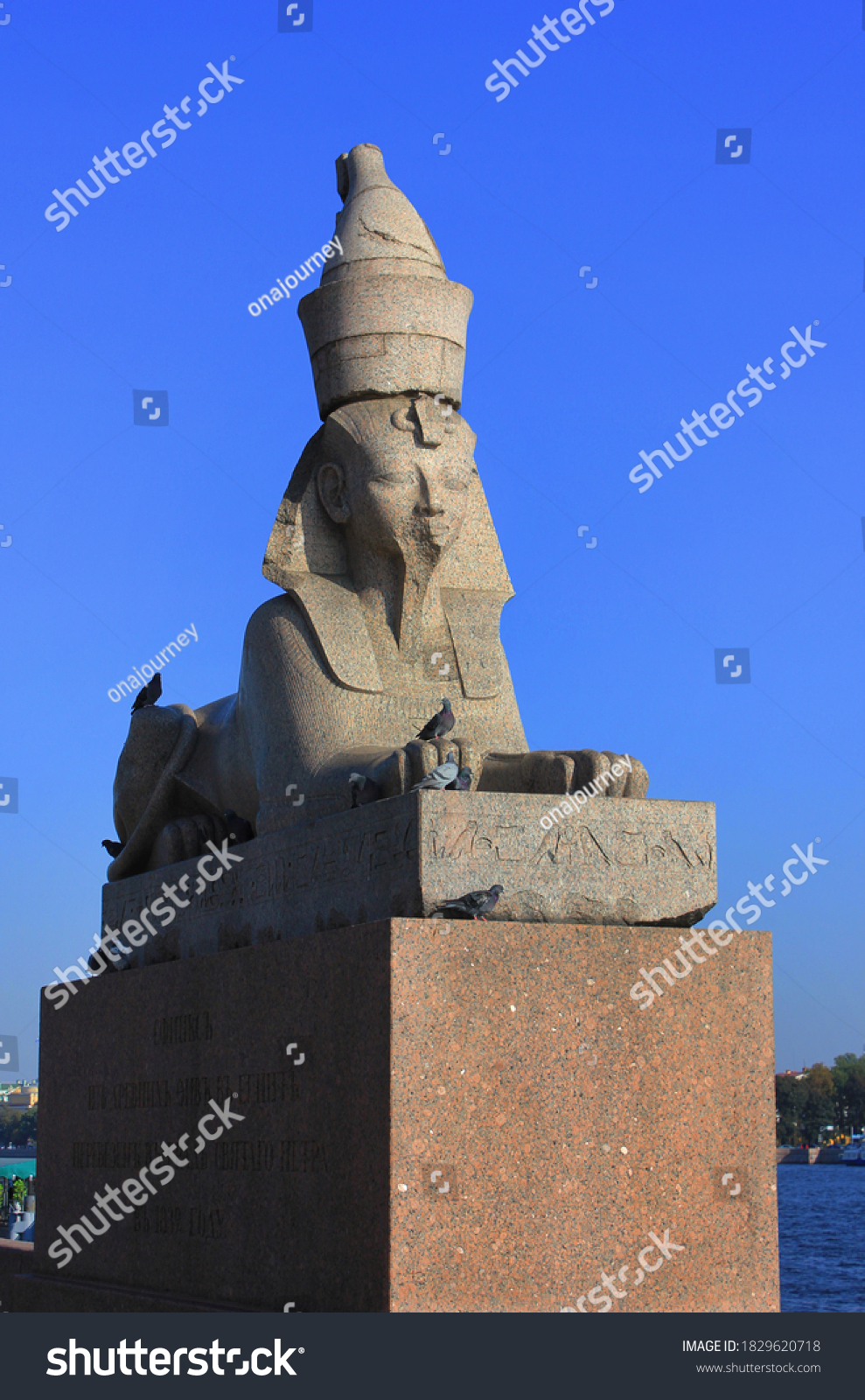 Ancient egyptian sphinx statue on quay with sphinxes at the Neva river embankment in St Petersburg, Russia. Historic old granite sphinxes statue in St Petersburg city #1829620718