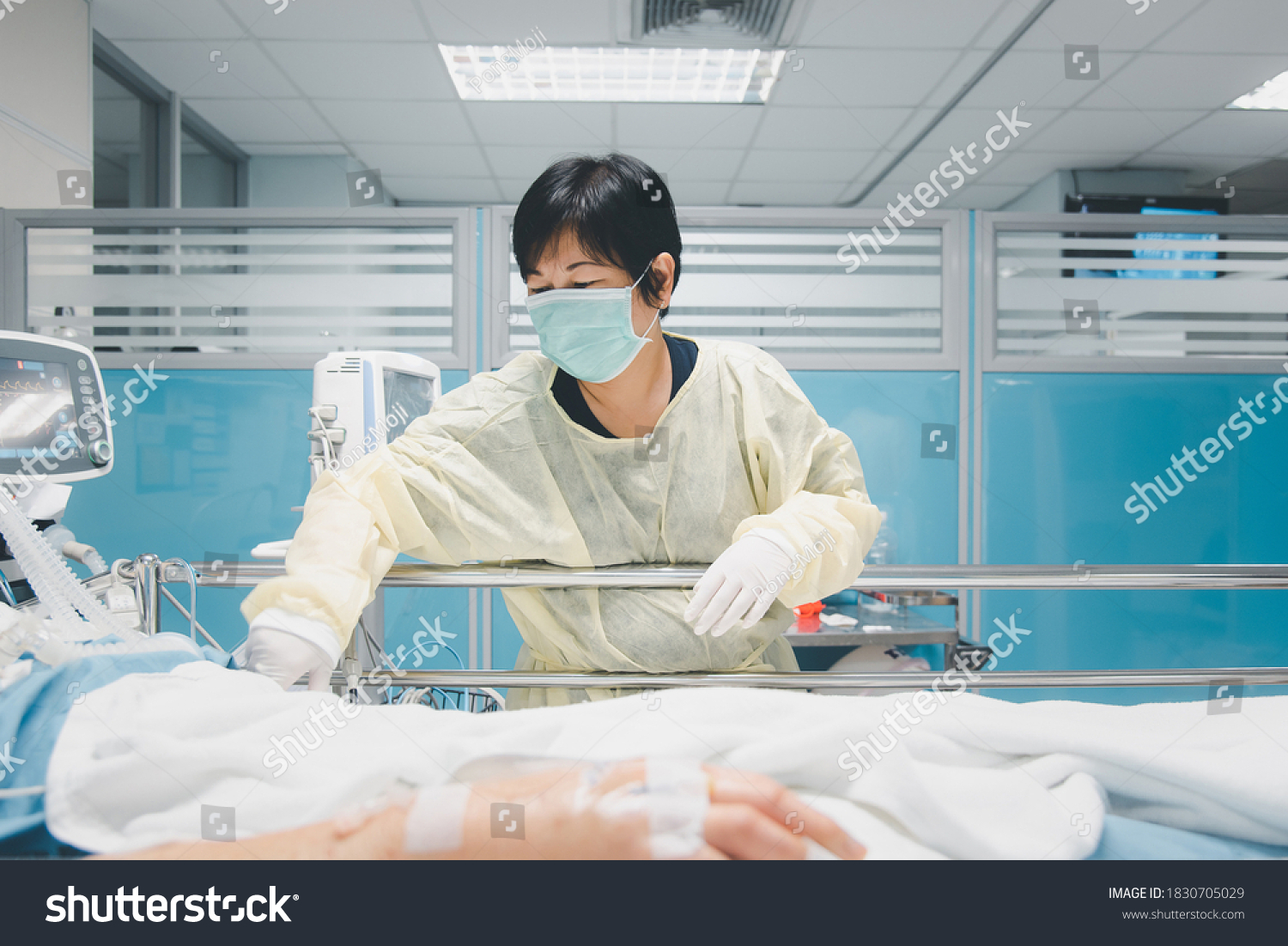 Doctor use monitor with vital signs for medical care of the flu covid19, corona virus, CRE. or VRE. infected elder patient 80s years old on patient bed in intensive care unit (ICU.) room at hospital #1830705029