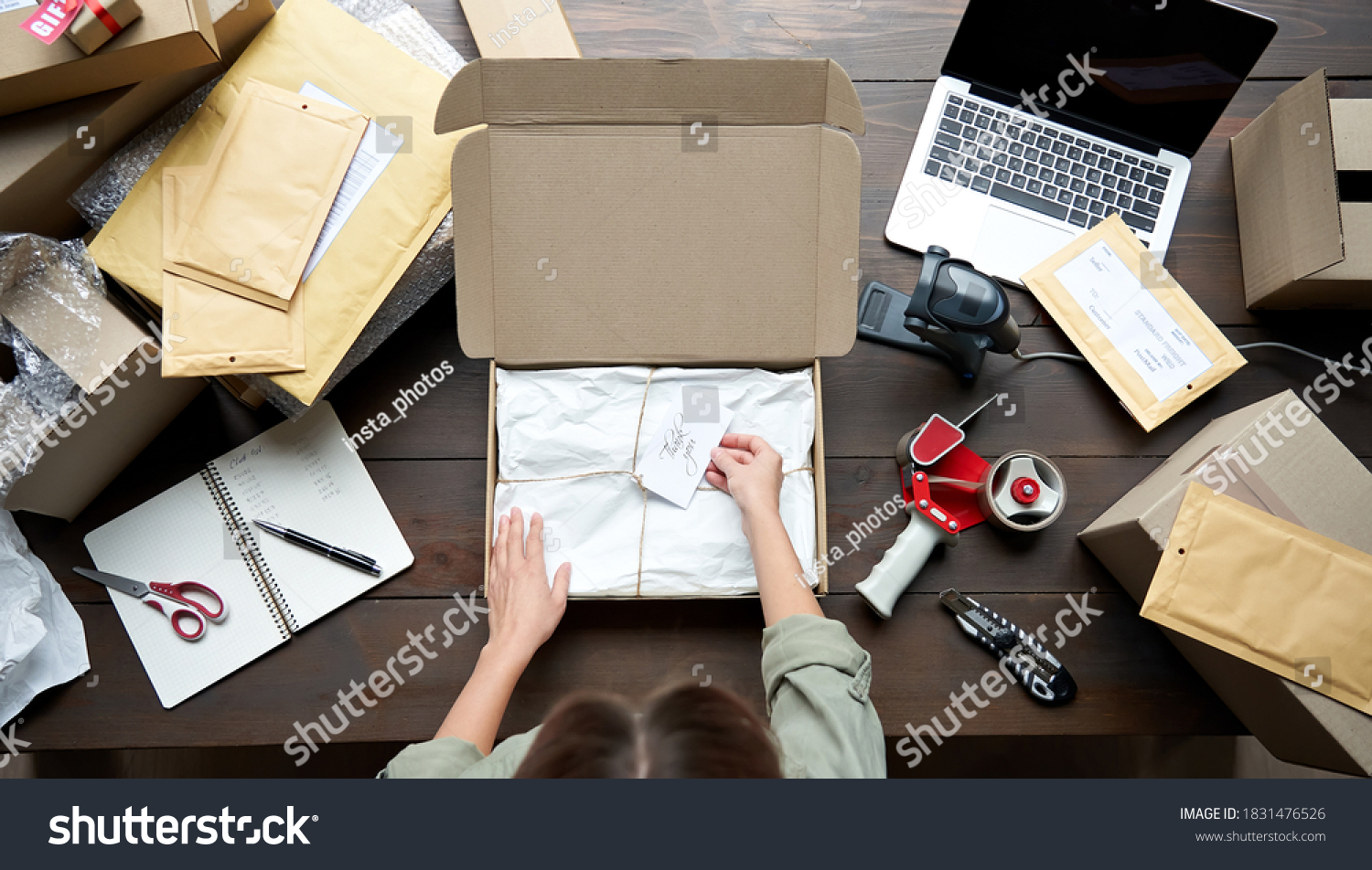 Top above closeup view of female online store small business owner entrepreneur packing package post shipping box preparing delivery parcel on table. Ecommerce dropshipping shipment service concept. #1831476526