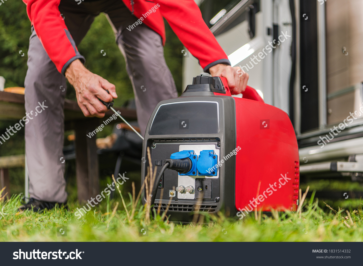 Caucasian Men in His 40s Firing Up Gas Powered Portable Inverter Generator To Connect Electricity To His Camper Van.  #1831514332