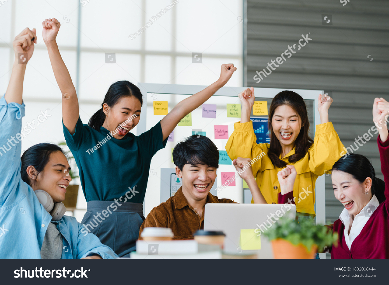 Group of Asia young creative people in smart casual wear discussing business celebrate giving five after dealing feeling happy and signing contract or agreement in office. Coworker teamwork concept. #1832008444