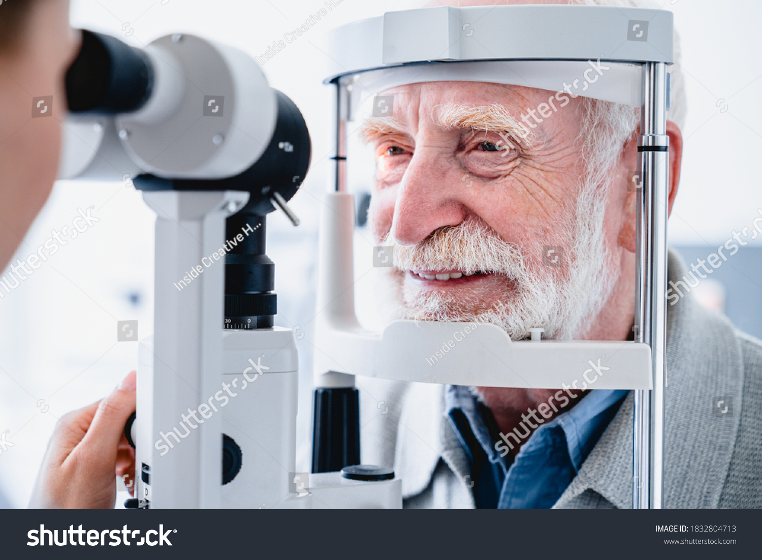 Close up photo of smiling senior male patient during sight examination #1832804713