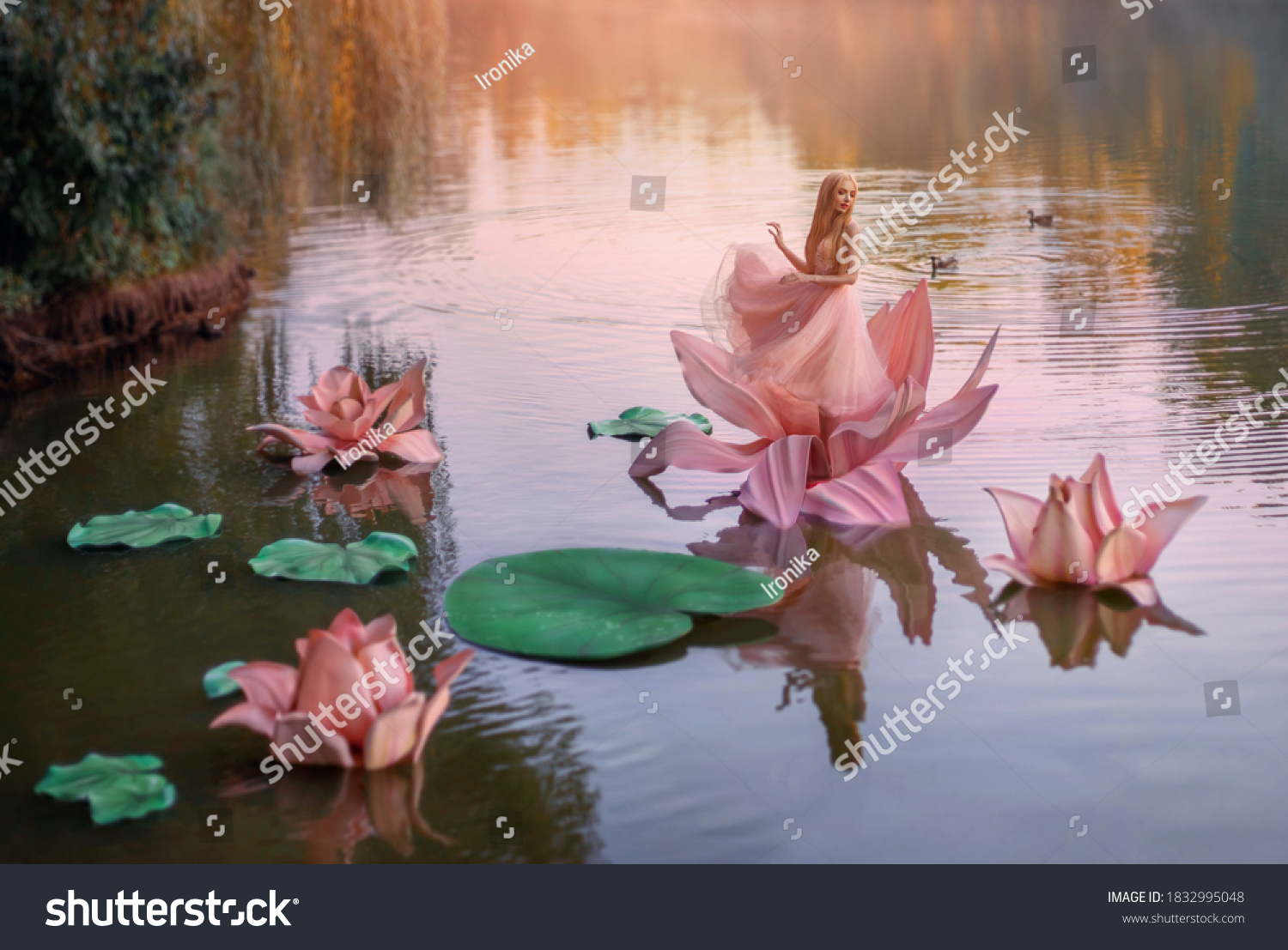 art photo fantasy. Autumn magic miracle. small blonde happy woman princess stands dancing in pink big huge lotus lily flower, on water of river. Short dress. image child of nature. Cartoon character #1832995048