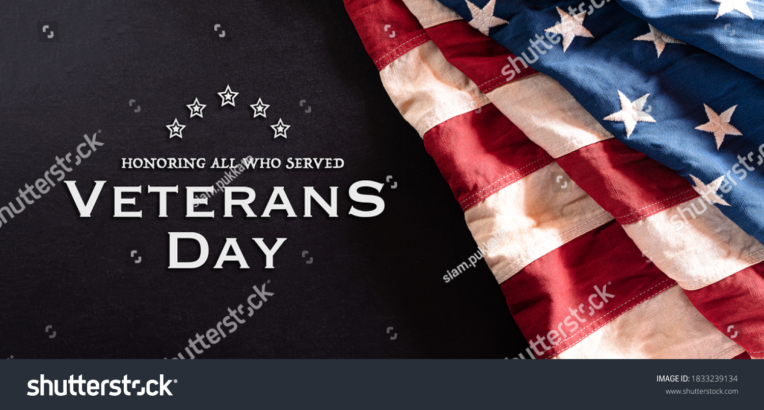 Happy Veterans Day concept. Vintage American flags against blackboard  background. November 11. #1833239134