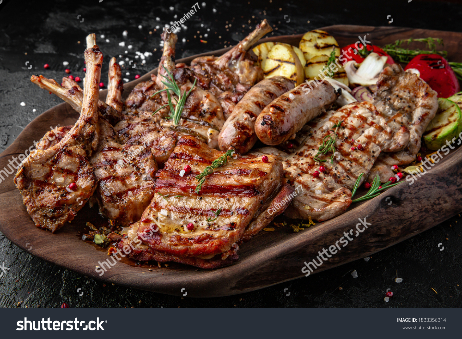 Different types of cooked meat, beef, rack of lamb and grilled pork, chicken and turkey baked in sauce, sausages with vegetables #1833356314