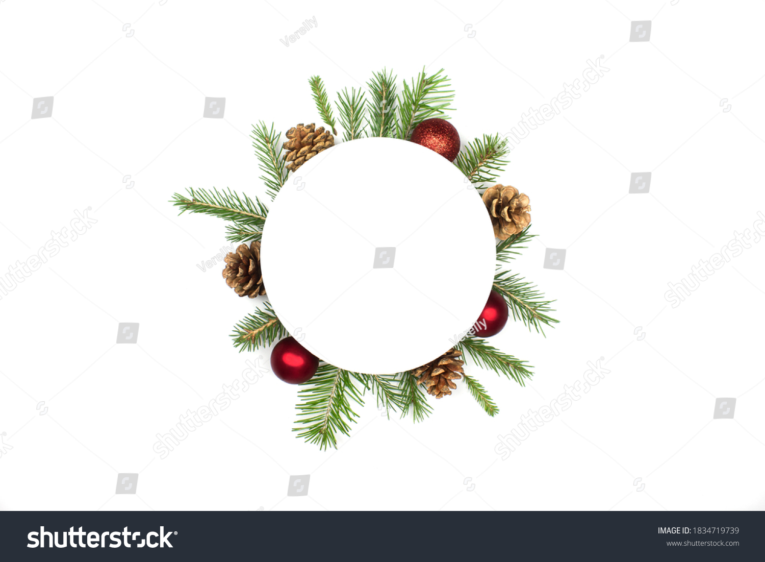 Christmas round frame mockup made of spruce branches, red decorations, fir cones flat lay isolated on white background, copy space. Christmas composition with wreath top view. Xmas celebration #1834719739