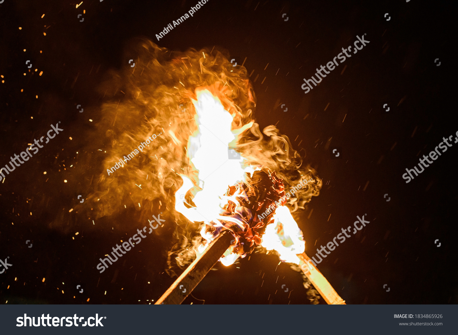 two burning torches on a dark background, smoke and fire from burning torches. #1834865926