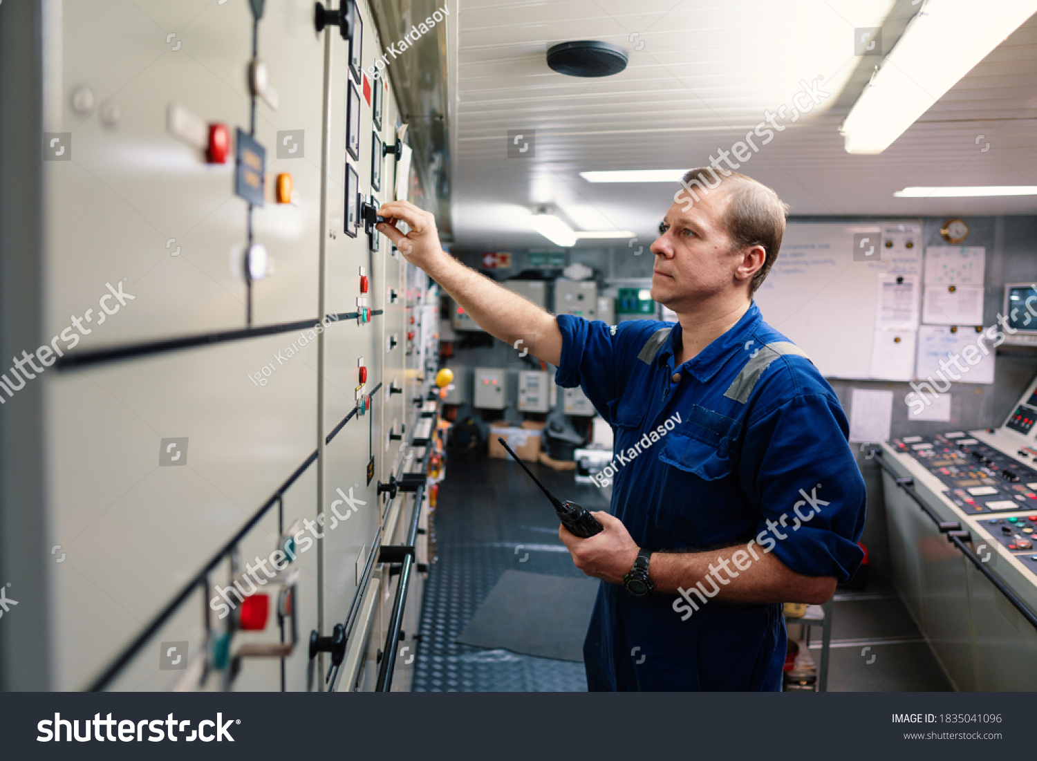 Marine engineer officer controlling vessel engines and propulsion in engine control room ECR. Ship maintenance Start or stop of main engine #1835041096