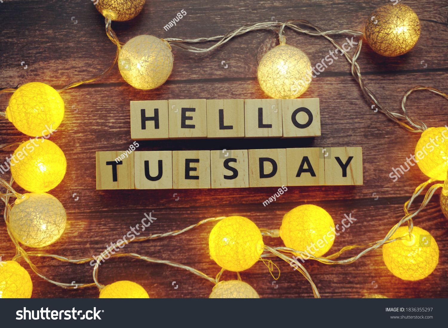 Hello Tuesday alphabet letter with LED cotton balls on wooden background #1836355297