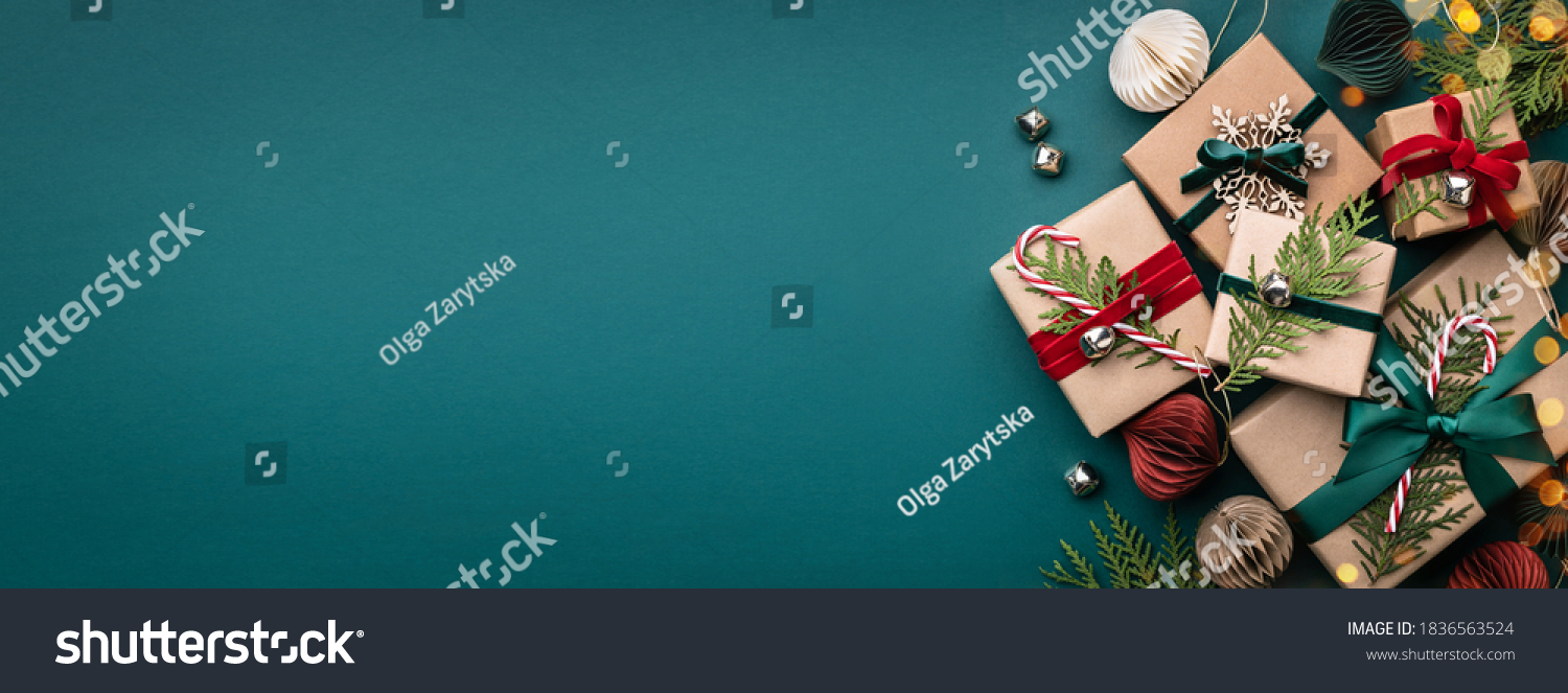 Banner with many gift boxes tied velvet ribbons and paper decorations on turquoise background. Christmas background. #1836563524