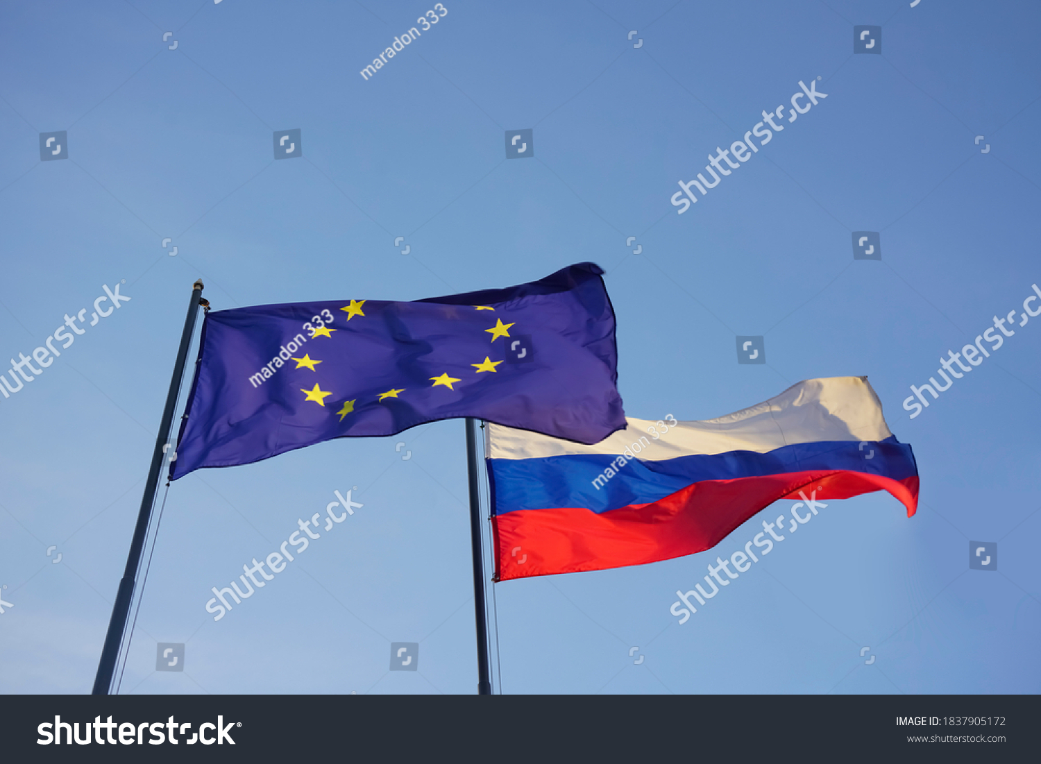 European Union -  EU -  and Russian Federation flags on background of blue sky. Europa and Russia.  #1837905172