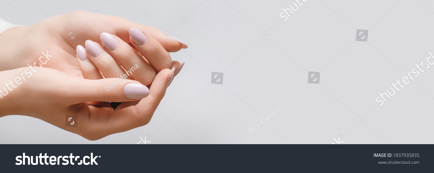 Female hands with rose nail design. Pink glitter nail polish manicure. Woman hands on white background. Banner #1837935835