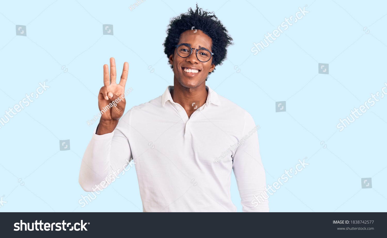 Handsome african american man with afro hair wearing casual clothes and glasses showing and pointing up with fingers number three while smiling confident and happy.  #1838742577