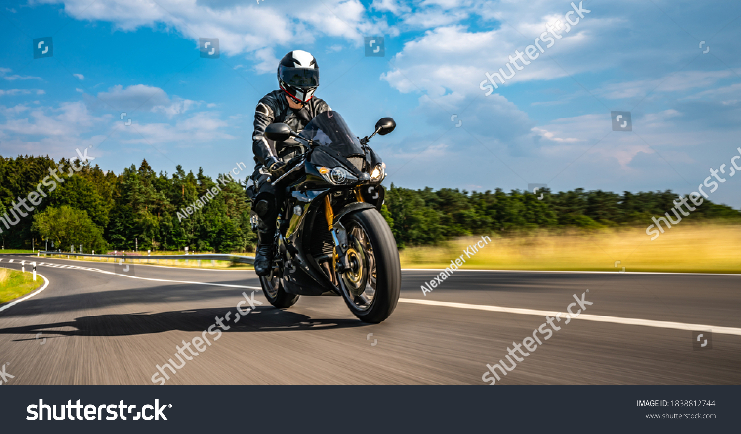motorbike on the road riding. having fun driving the empty road on a motorcycle tour journey. copyspace for your individual text. Fast Motion Blur effect #1838812744