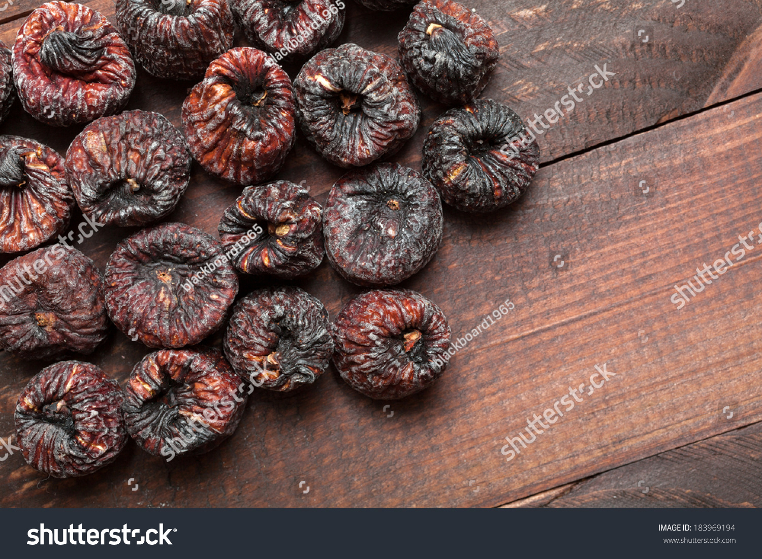 Dried black figs on a wooden surface #183969194