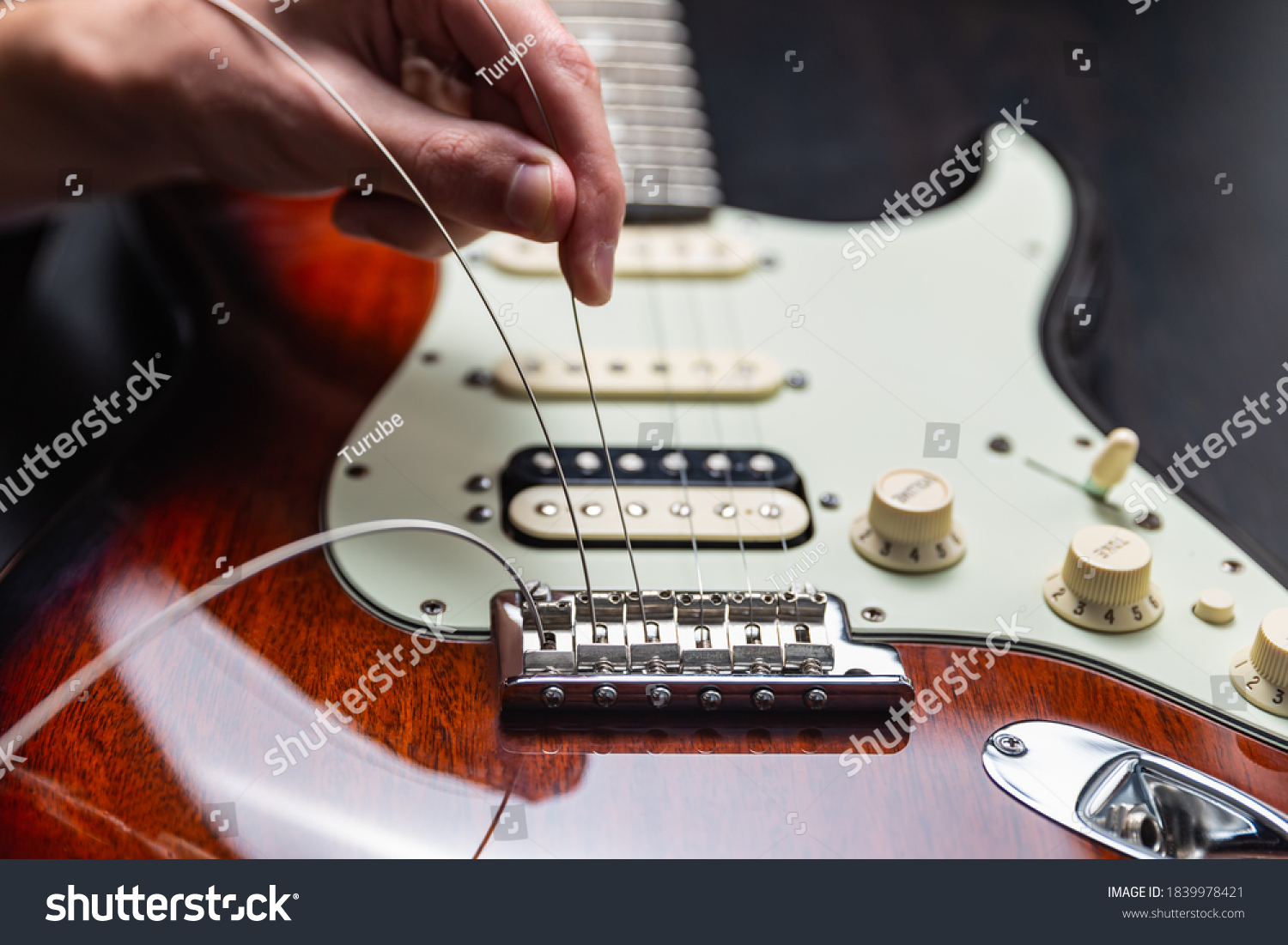 Replacing strings on an electric guitar #1839978421