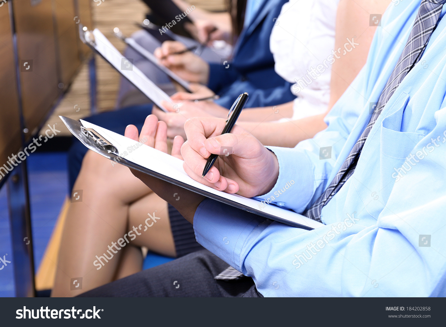 Hands holding pens and making notes at conference #184202858