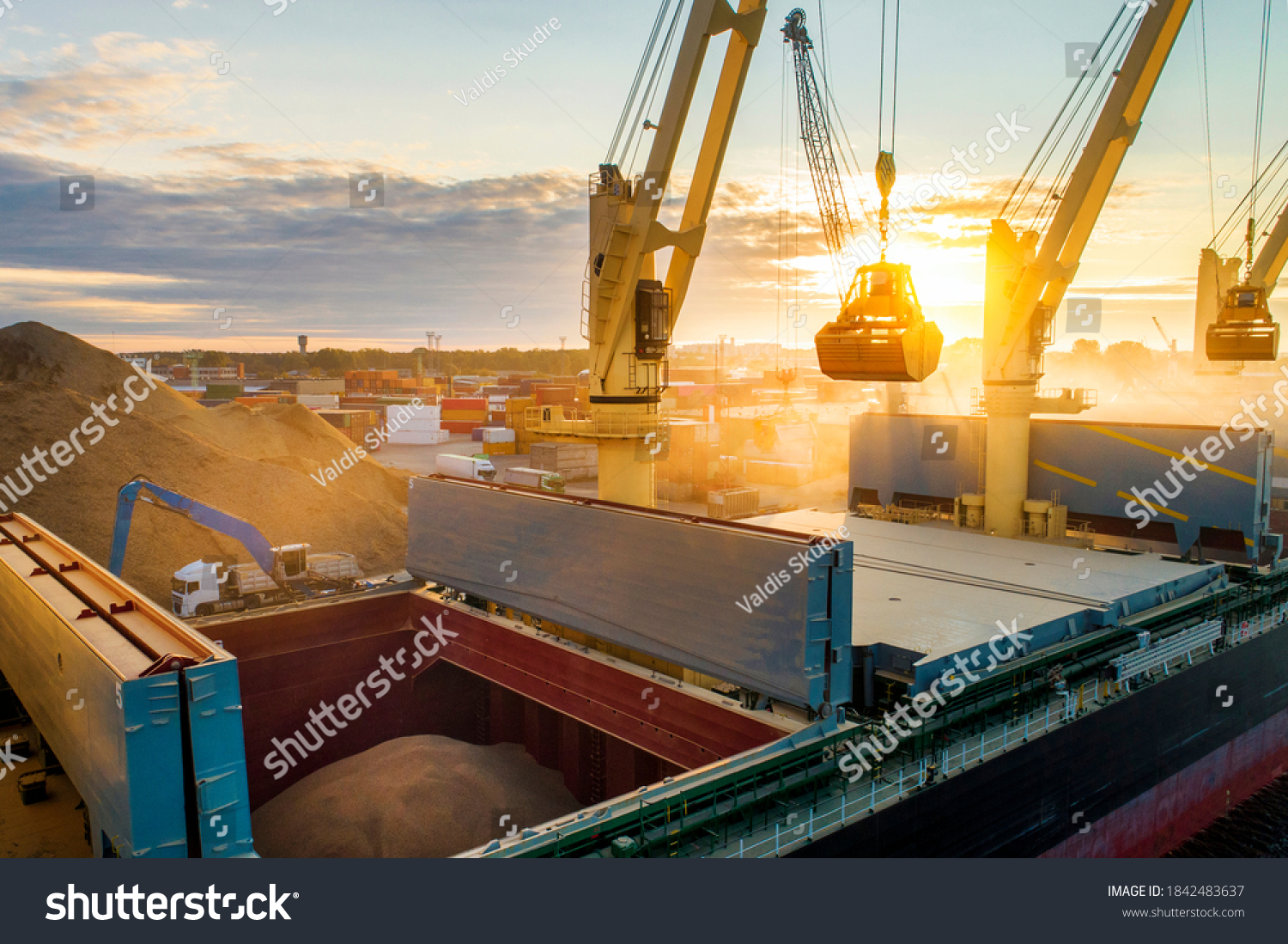 Large international transportation vessel in the port, loading grain during sunrise for export in the sea waters. #1842483637