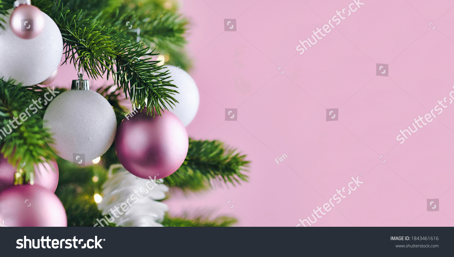 Banner with Christmas tree decorated with white and pink seasonal tree ornament baubles on pink background with empty copy space #1843461616