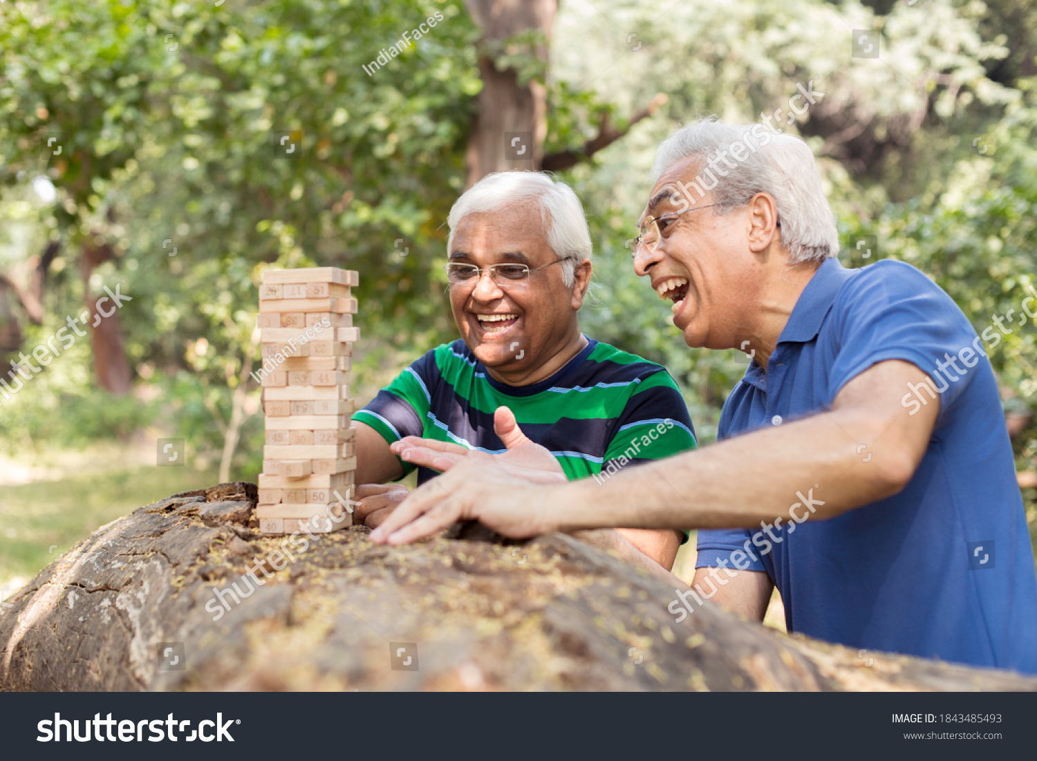 Men playing wooden blocks in park #1843485493