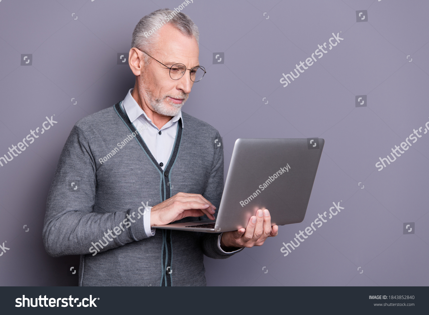 Portrait of his he nice attractive focused banker business shark wearing casual formal-wear using netbook e-commerce isolated over gray pastel background #1843852840