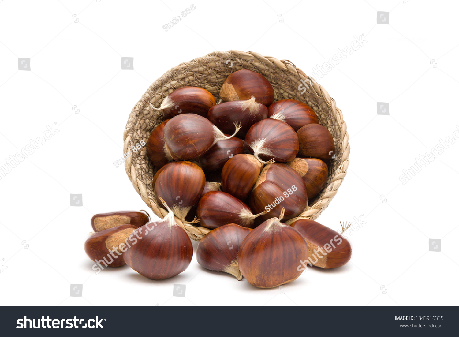 Fresh raw sweet chestnuts(Castanea sativa) in a wicker basket isolated on a white background #1843916335