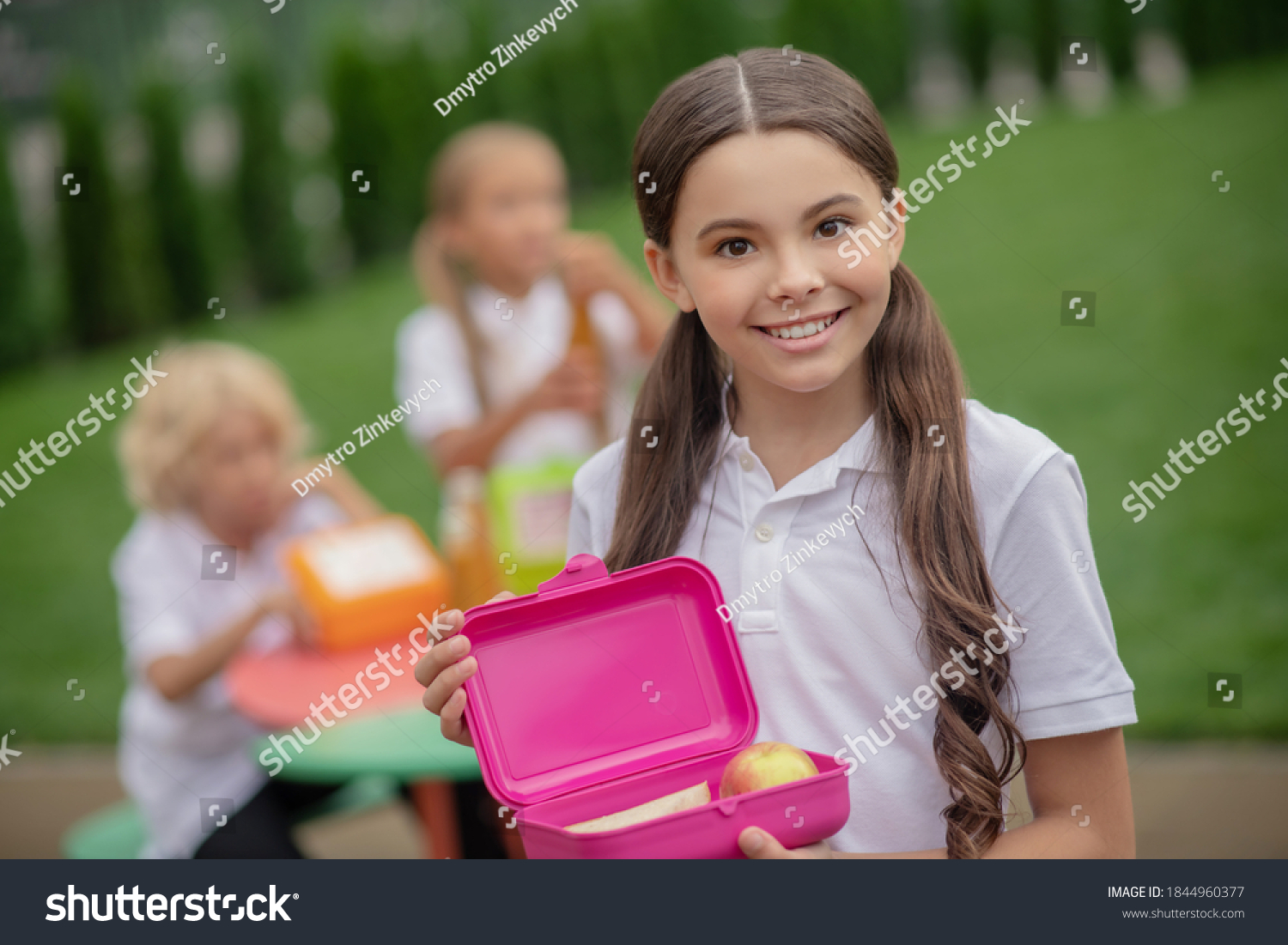 Lunch. A girl with a lunch box smiling nicely #1844960377