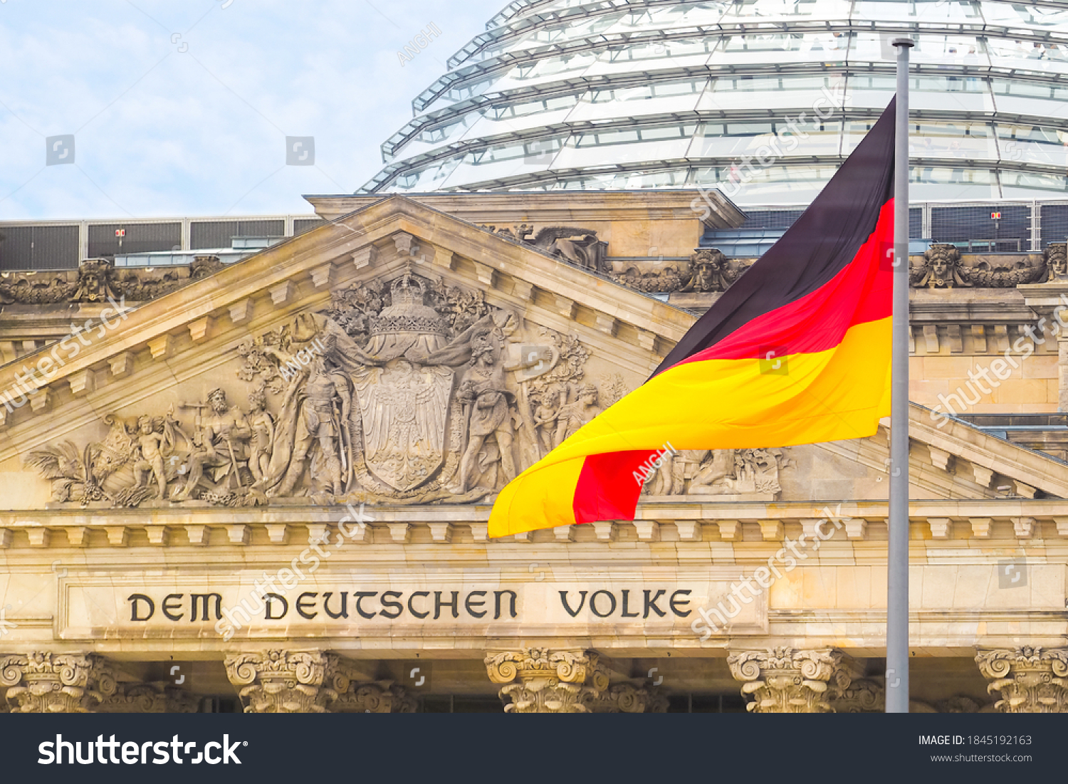 German flag on a background Reichstag building. The seat of the German Parliament or Bundestag, Berlin Mitte district. Inscription in German: To the German People #1845192163