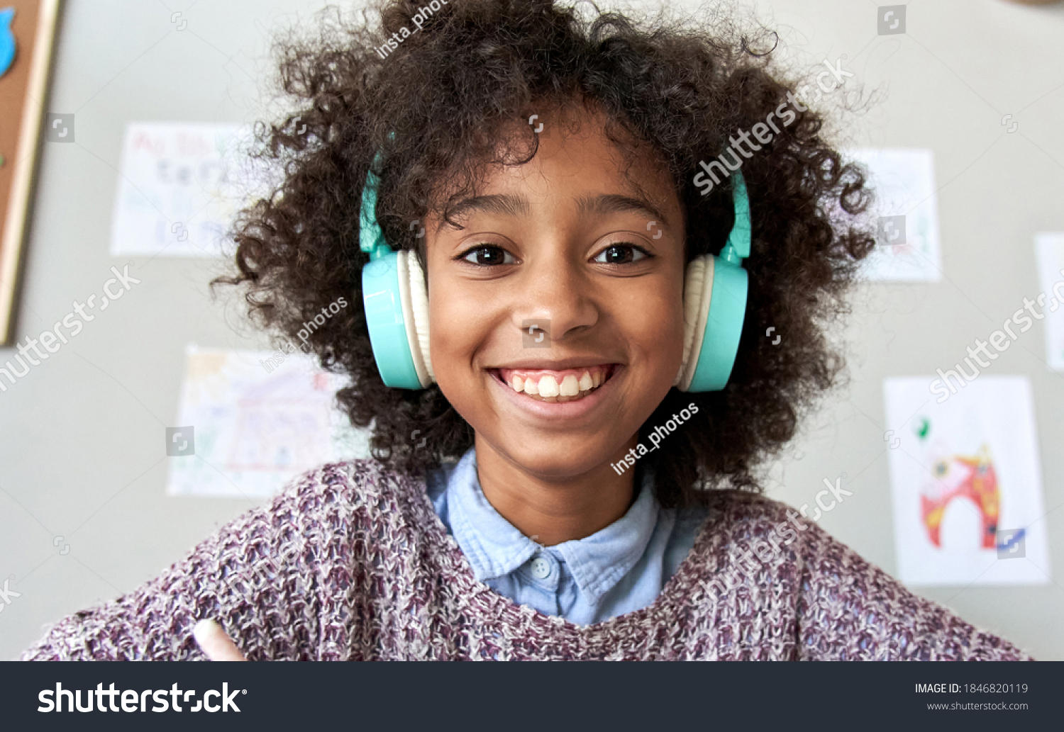 Happy african american mixed race kid child girl wearing headphones looking at camera or web cam remote distance learning on video zoom conference call, virtual class, headshot close up face portrait. #1846820119