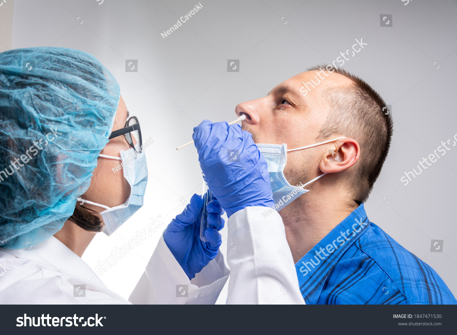 Coronavirus test - Medical worker taking a swab for corona virus sample from potentially infected man. covid-19 nasal swab test - doctor taking a mucus sample from patient nose in hospital #1847471530