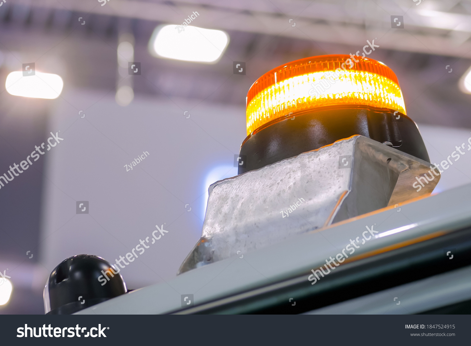 Close up of warning orange beacon flashing on roof of emergency, support and service vehicle. Danger, legal, alert light, attention and hazard concept #1847524915